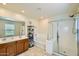 Bright bathroom featuring a double sink vanity, tub and glass enclosed shower at 2955 E Flossmoor Ave, Mesa, AZ 85204