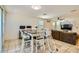 A dining space with a modern table, chairs, and view of the living room at 2955 E Flossmoor Ave, Mesa, AZ 85204