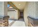 Covered front entrance with stucco walls and brick pillars leading to the front door at 2955 E Flossmoor Ave, Mesa, AZ 85204
