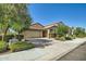 Exterior shot features a two-car garage, neutral paint, and desert landscaping at 2955 E Flossmoor Ave, Mesa, AZ 85204