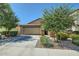 A charming home features a spacious driveway, two-car garage, and well-maintained landscaping at 2955 E Flossmoor Ave, Mesa, AZ 85204