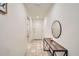 Inviting hallway with tile flooring, a decorative table, and neutral paint at 2955 E Flossmoor Ave, Mesa, AZ 85204