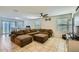 Bright living room with large sectional sofa, tile flooring, and sliding door access at 2955 E Flossmoor Ave, Mesa, AZ 85204