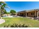 Large backyard featuring a pool, patio, covered seating area, and green lawn at 3006 E Lexington Ave, Gilbert, AZ 85234