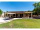 Expansive backyard featuring lush green lawn, covered patios, and outdoor seating areas at 3006 E Lexington Ave, Gilbert, AZ 85234