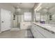 Serene bathroom with dual sinks, white cabinets, a shower, and a soaking tub at 3006 E Lexington Ave, Gilbert, AZ 85234