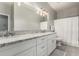 Bathroom featuring dual sinks, granite countertop, and modern lighting at 3006 E Lexington Ave, Gilbert, AZ 85234
