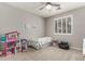 Bright bedroom with plantation shutters, carpet, and a playful ' dollhouse at 3006 E Lexington Ave, Gilbert, AZ 85234