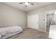 Neutral bedroom featuring carpet floors, a ceiling fan, and a closet with sliding doors at 3006 E Lexington Ave, Gilbert, AZ 85234