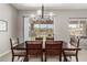 Dining area featuring a contemporary chandelier and a sliding glass door that leads to the backyard at 3006 E Lexington Ave, Gilbert, AZ 85234