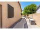 Exterior view of the side of a home showing the landscaping and neutral color palette at 3006 E Lexington Ave, Gilbert, AZ 85234