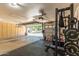 Spacious garage featuring built in cabinets, gym equipment, and epoxy floors at 3006 E Lexington Ave, Gilbert, AZ 85234