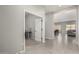 Hallway with tile flooring leading to an office space and kitchen area at 3006 E Lexington Ave, Gilbert, AZ 85234