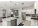 Bright kitchen with white cabinets, granite counters, stainless steel appliances, and a functional island at 3006 E Lexington Ave, Gilbert, AZ 85234