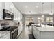Modern kitchen featuring sleek appliances, white cabinets, granite countertops and an open layout at 3006 E Lexington Ave, Gilbert, AZ 85234