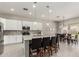 Bright, open concept kitchen and dining area with white cabinetry, stainless appliances and a breakfast bar at 3006 E Lexington Ave, Gilbert, AZ 85234