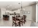 Open concept kitchen and dining area with modern white cabinetry, stainless appliances and a breakfast bar at 3006 E Lexington Ave, Gilbert, AZ 85234