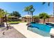 Beautiful backyard pool featuring mature landscaping and a lounge area with shade at 3006 E Lexington Ave, Gilbert, AZ 85234