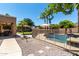 Backyard pool with safety fence, mature landscaping, and outdoor living space at 3006 E Lexington Ave, Gilbert, AZ 85234