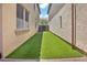 Artificial grass in the backyard between houses at 3036 N Acacia Way, Buckeye, AZ 85396
