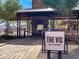 Exterior view of bar area featuring a fireplace, outdoor seating, and views of the surrounding landscape at 3036 N Acacia Way, Buckeye, AZ 85396