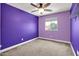 This bedroom offers neutral carpet flooring, a ceiling fan, and a window at 3036 N Acacia Way, Buckeye, AZ 85396