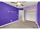 This bedroom features neutral carpet, a ceiling fan, and an open closet at 3036 N Acacia Way, Buckeye, AZ 85396