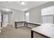Bedroom with built-in desks, carpeted floors, and abundant natural light at 3036 N Acacia Way, Buckeye, AZ 85396