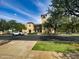 Exterior view of the Community Center featuring a clock tower, multiple stories, and ample parking at 3036 N Acacia Way, Buckeye, AZ 85396