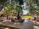 Picturesque fountain surrounded by mature trees, benches, and pavers creating a relaxing community space at 3036 N Acacia Way, Buckeye, AZ 85396