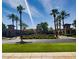 Scenic view of the Verrado Golf Club entrance, featuring manicured landscaping, palm trees, and the club's sign at 3036 N Acacia Way, Buckeye, AZ 85396