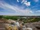 Expansive golf course view featuring rolling greens, a tranquil lake, and desert landscaping in the background at 3036 N Acacia Way, Buckeye, AZ 85396