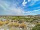 Expansive golf course view with rolling green hills, water features, and mountain views at 3036 N Acacia Way, Buckeye, AZ 85396