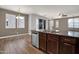Kitchen island with stainless appliances and views of a dining area and living area at 3036 N Acacia Way, Buckeye, AZ 85396