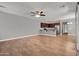 Spacious living area with wood floors that opens into the adjacent kitchen at 3036 N Acacia Way, Buckeye, AZ 85396