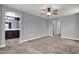 The living room includes neutral carpet and entry to the bathroom at 3036 N Acacia Way, Buckeye, AZ 85396