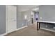 Loft area with a view of the laundry room and featuring built in desk, carpeted floors and neutral decor at 3036 N Acacia Way, Buckeye, AZ 85396