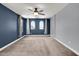 The main bedroom features neutral carpet, a ceiling fan, and 3 large windows at 3036 N Acacia Way, Buckeye, AZ 85396