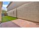 Private backyard patio featuring brick pavers and artificial grass, perfect for outdoor entertaining at 3036 N Acacia Way, Buckeye, AZ 85396