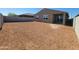 Large backyard with access to the house through sliding glass doors, awaiting personalization and landscaping at 37386 W San Sisto Ave, Maricopa, AZ 85138