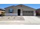 Charming single-story home with a neutral color scheme, complemented by a tidy, low-maintenance front yard at 37386 W San Sisto Ave, Maricopa, AZ 85138