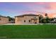 Large backyard with green lawn, patio, basketball court and pool, perfect for outdoor activities at 3944 W Paradise Ln, Phoenix, AZ 85053