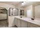Bathroom featuring a double sink vanity and separate glass-enclosed shower, and a walk-in closet at 3944 W Paradise Ln, Phoenix, AZ 85053