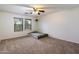 Bright, carpeted bedroom with a ceiling fan and windows providing ample natural light at 3944 W Paradise Ln, Phoenix, AZ 85053