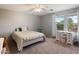 Cozy bedroom with carpet floors, natural light, a ceiling fan, and a vintage vanity at 3944 W Paradise Ln, Phoenix, AZ 85053
