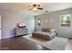 Inviting bedroom with wood floors, gray accent wall, and comfortable bed with patterned rug at 3944 W Paradise Ln, Phoenix, AZ 85053