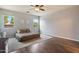 Spacious bedroom featuring wood floors, natural light, ceiling fan and calming decor at 3944 W Paradise Ln, Phoenix, AZ 85053
