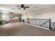 Spacious bonus room or loft area with carpet flooring and railing overlooking downstairs at 3944 W Paradise Ln, Phoenix, AZ 85053