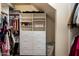 Organized walk-in closet with custom shelving and storage for clothing and accessories at 3944 W Paradise Ln, Phoenix, AZ 85053