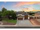 Attractive two-story home with a well-manicured lawn, mature trees, and a three-car garage at 3944 W Paradise Ln, Phoenix, AZ 85053
